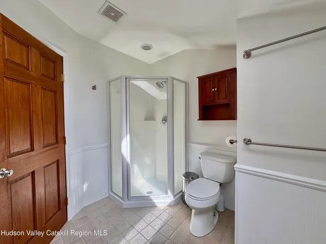a hallway with wooden floor and furniture