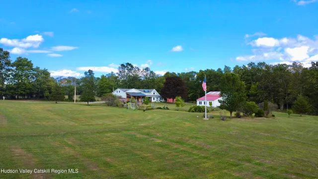 a big house with a big yard and more large trees