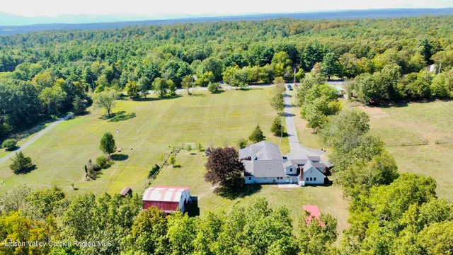 an aerial view of a house with a yard and lake view