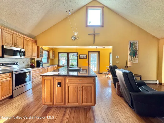 a living room with fireplace furniture and a large window