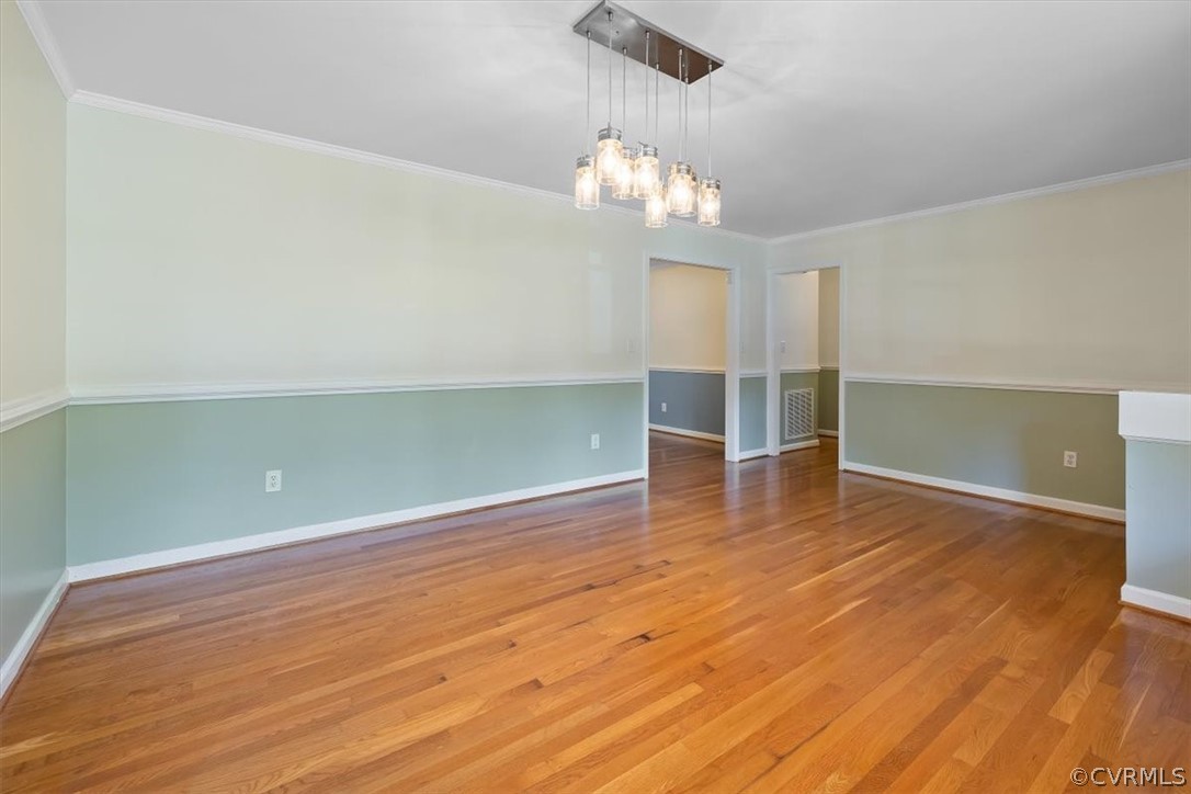 13012 Harrowgate Road Chester, VA 23831 - Photo 11 of 28 an empty room with wooden floor chandelier and windows