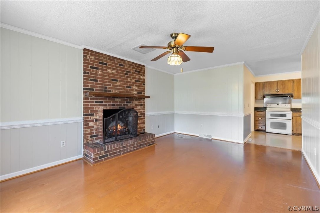 13012 Harrowgate Road Chester, VA 23831 - Photo 13 of 28 a view of a livingroom with a fireplace and wooden floor
