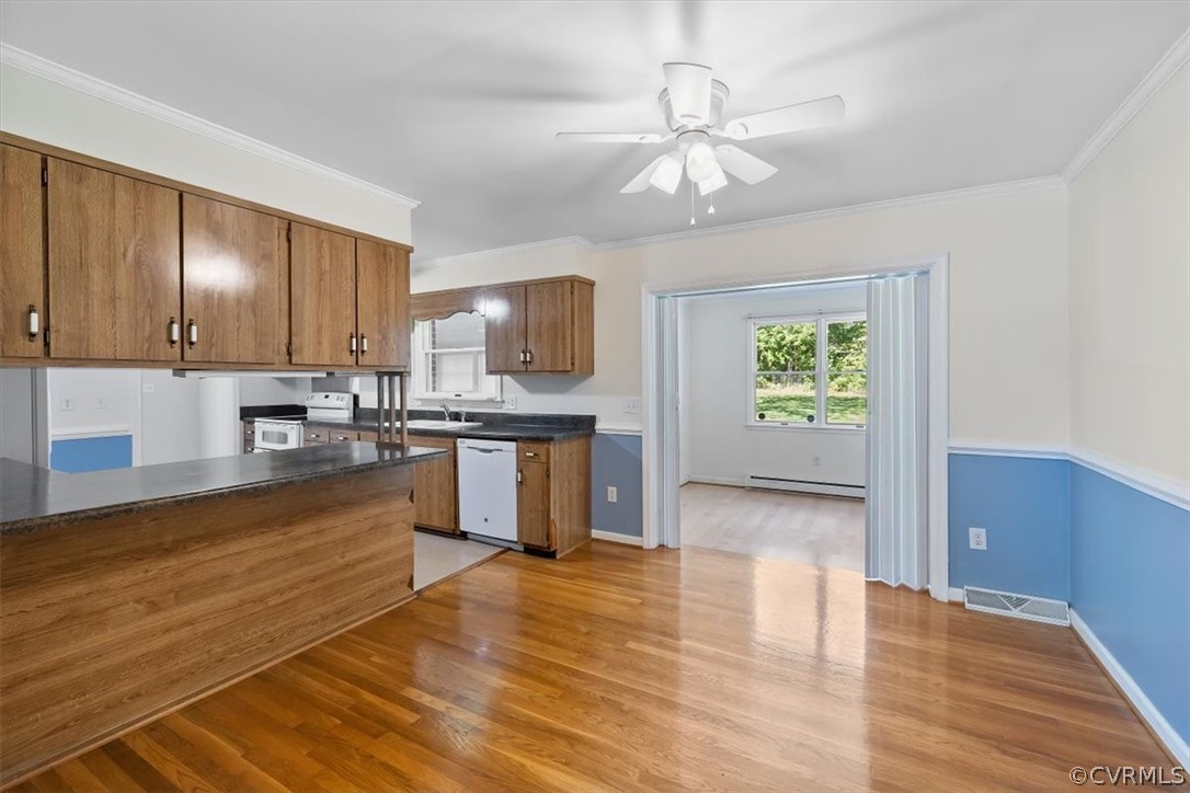 13012 Harrowgate Road Chester, VA 23831 - Photo 17 of 28 a large kitchen with cabinets wooden floor and stainless steel appliances