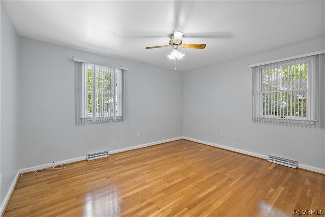 13012 Harrowgate Road Chester, VA 23831 - Photo 24 of 28 a view of an empty room with wooden floor and a window