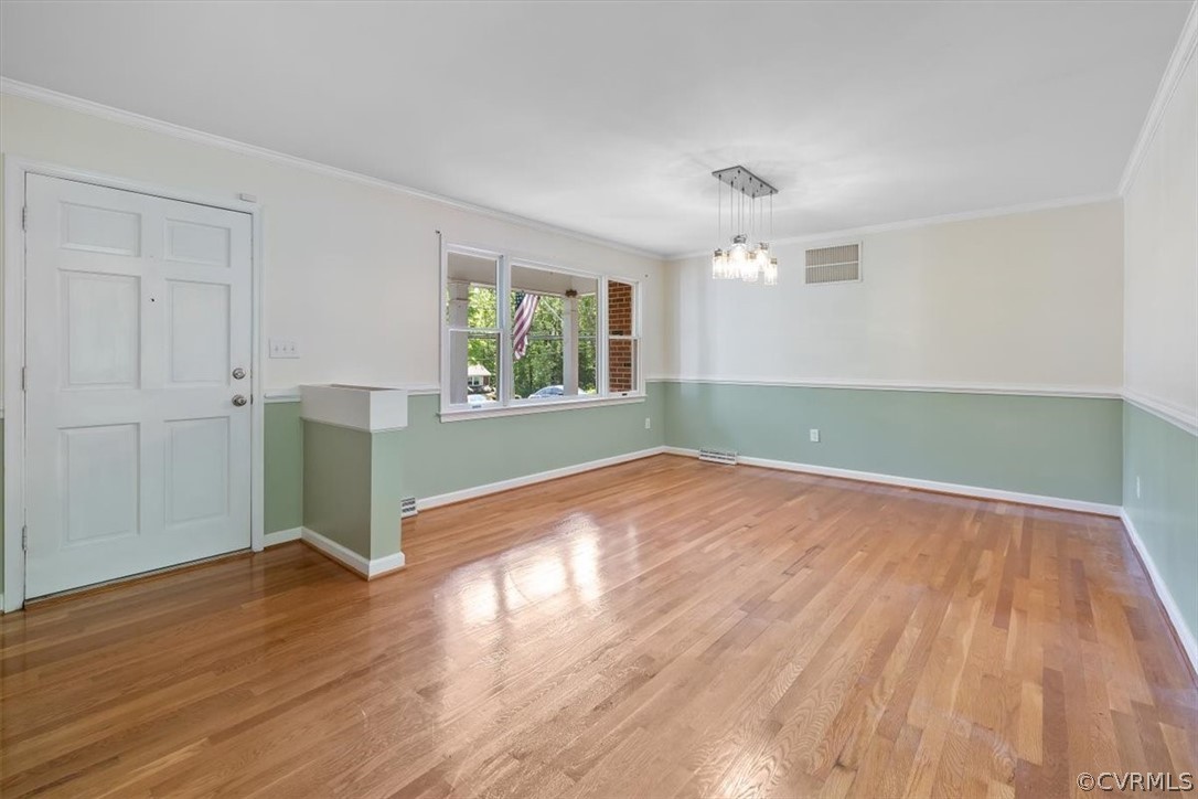 13012 Harrowgate Road Chester, VA 23831 - Photo 10 of 28 an empty room with wooden floor cabinet and windows