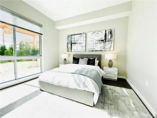 a bedroom with a large bed and a large window