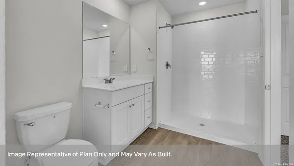 a bathroom with a shower a mirror and a sink