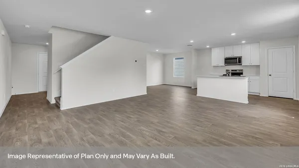 a view of kitchen with kitchen island microwave and stove