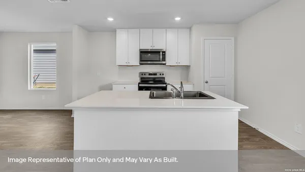 a kitchen with a sink a stove and microwave