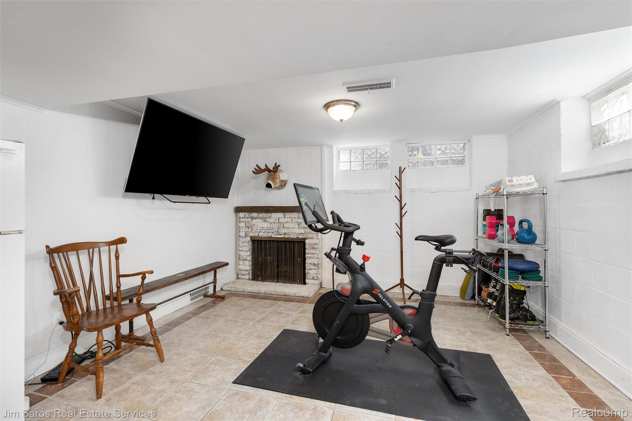 820 Westchester Road Grosse Pointe, MI 48230 - Photo 25 of 33 Workout room with healthy amount of natural light, a brick fireplace, and concrete block wall