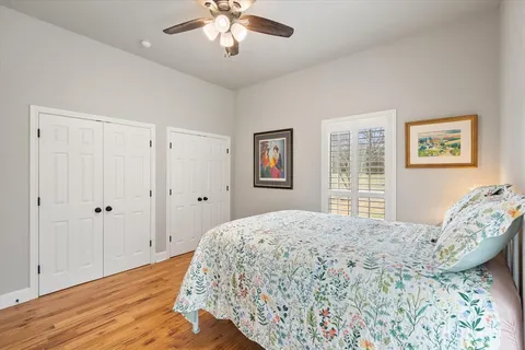 a spacious bathroom with a double vanity sink a mirror and a shower