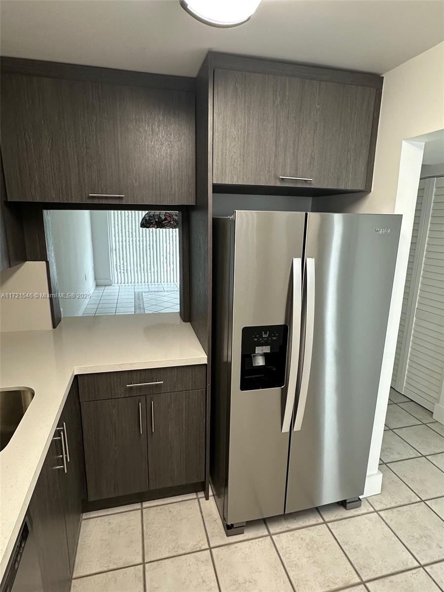1666 West Avenue, Unit 512 Miami Beach, FL 33139 - Photo 12 of 20 a kitchen with stainless steel appliances granite countertop a refrigerator and a stove