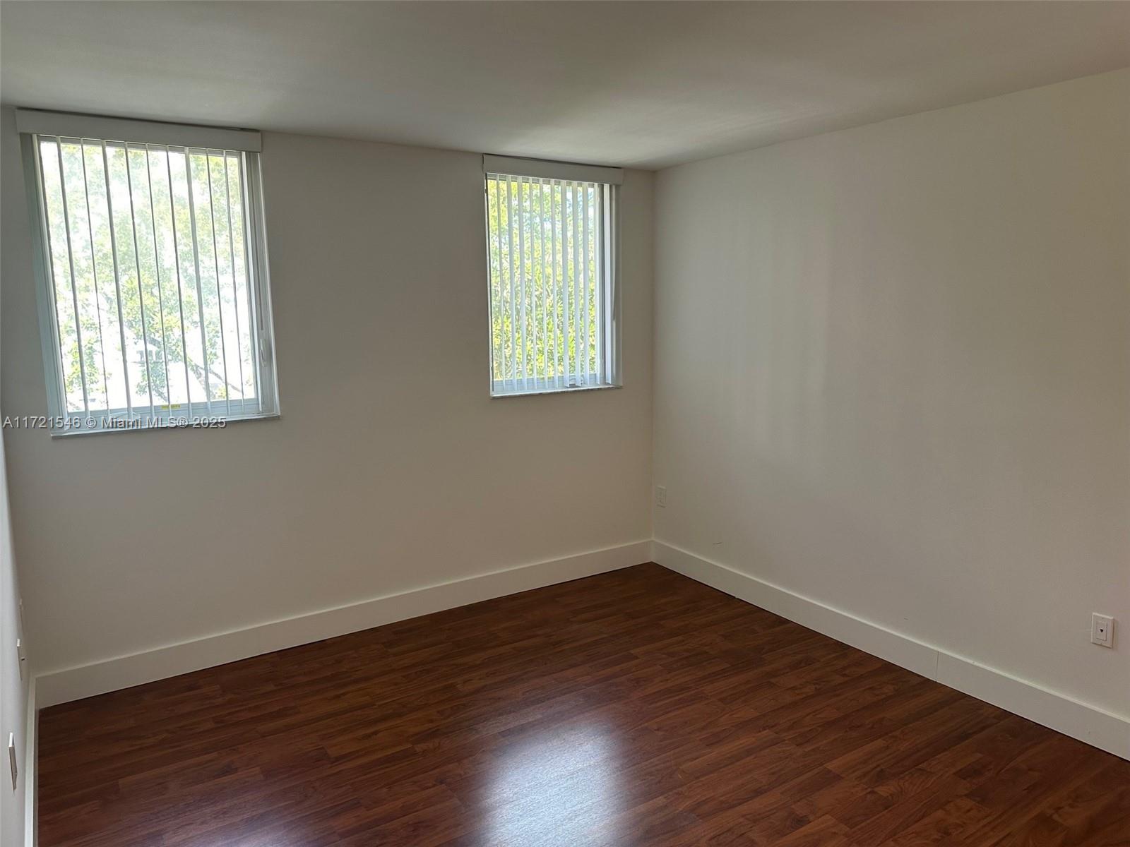 1666 West Avenue, Unit 512 Miami Beach, FL 33139 - Photo 17 of 20 a view of an empty room with wooden floor and a window
