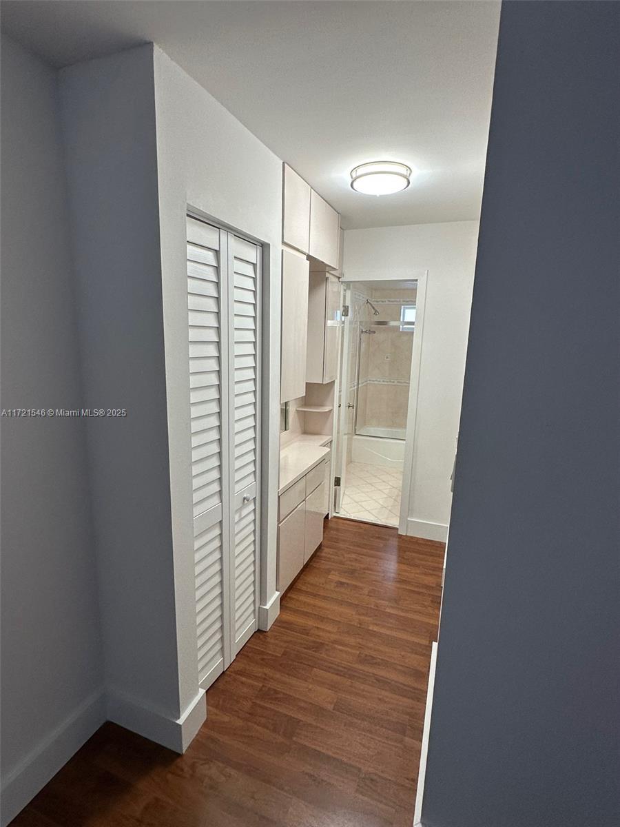 1666 West Avenue, Unit 512 Miami Beach, FL 33139 - Photo 18 of 20 a view of a hallway with wooden floor and closet
