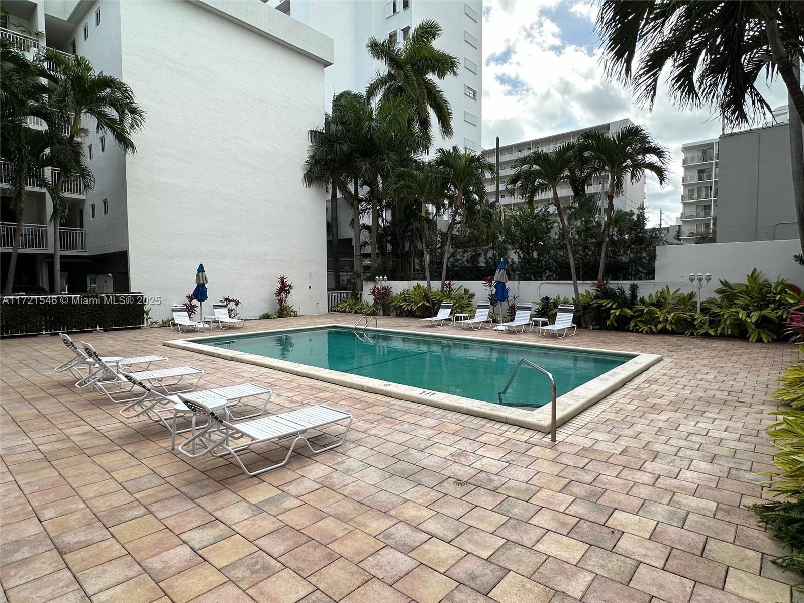 1666 West Avenue, Unit 512 Miami Beach, FL 33139 - Photo 3 of 20 a swimming pool with outdoor seating and yard