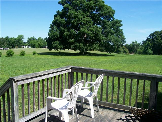 1198 Smith Thompson Road Bethpage, TN 37022 - Photo 4 of 20 a view of a wooden deck and a backyard