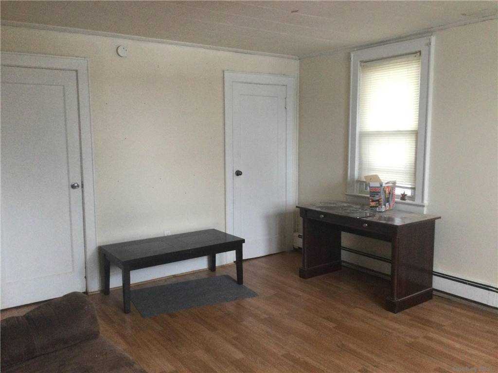 a room with wooden floor and furniture