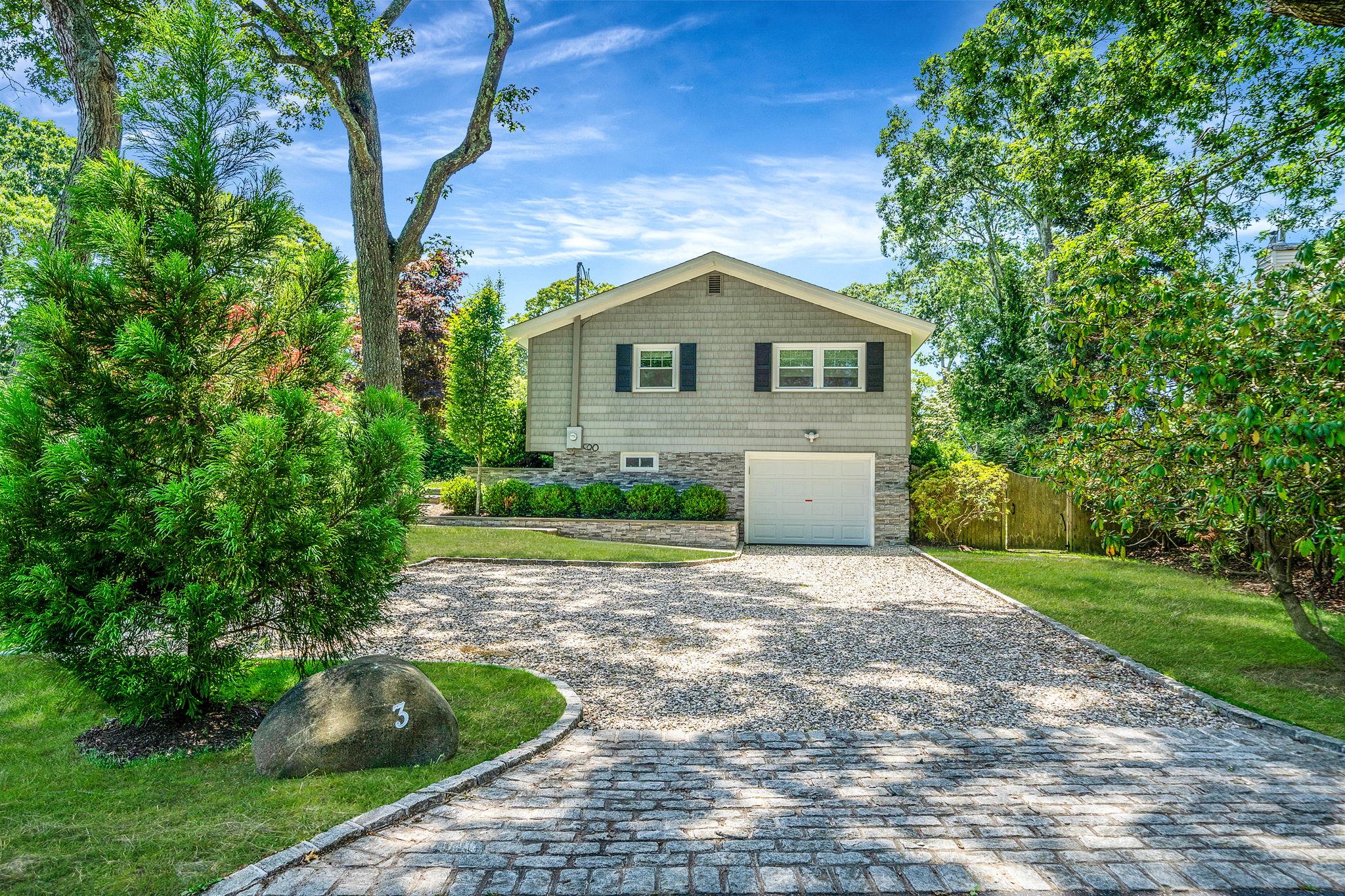 3 Crestview Drive Remsenburg, NY 11960 - Photo 12 of 24 a front view of a house with a yard and trees