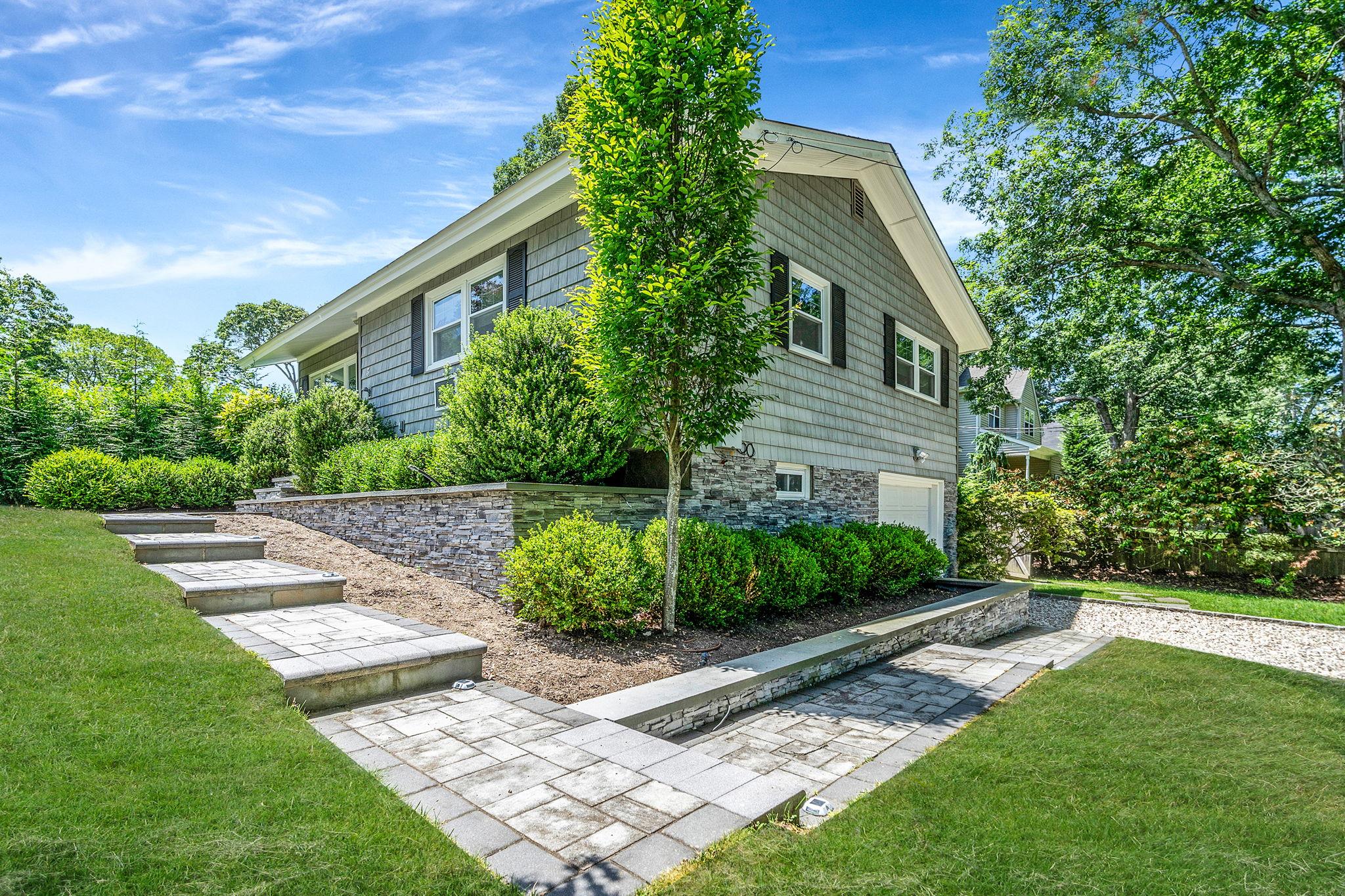 3 Crestview Drive Remsenburg, NY 11960 - Photo 13 of 24 a front view of a house with a yard