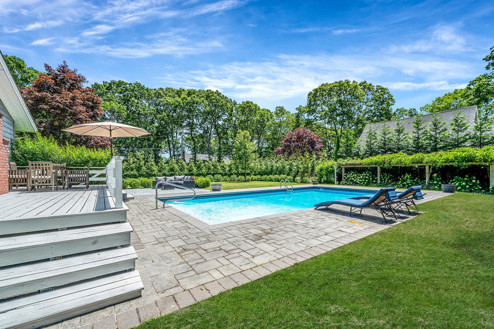 3 Crestview Drive Remsenburg, NY 11960 - Photo 16 of 21 a view of a garden with lawn chairs