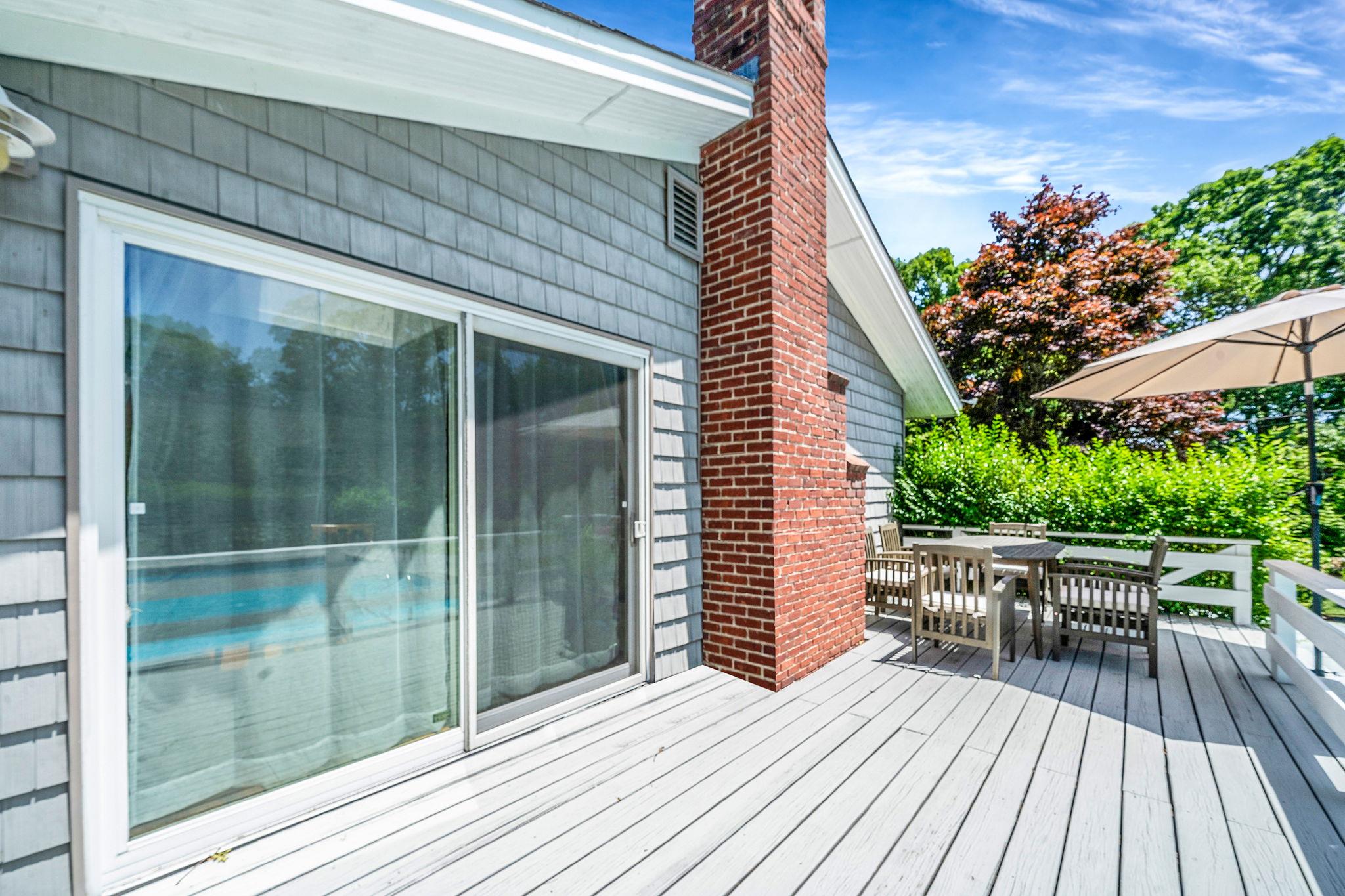 3 Crestview Drive Remsenburg, NY 11960 - Photo 16 of 24 a balcony with wooden floor table and chairs