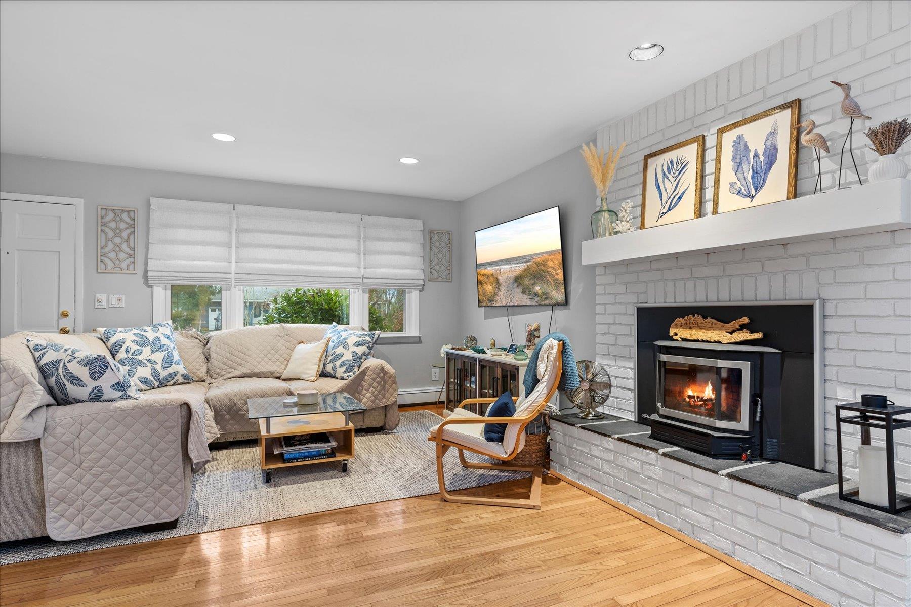 3 Crestview Drive Remsenburg, NY 11960 - Photo 4 of 24 a living room with furniture and a fireplace