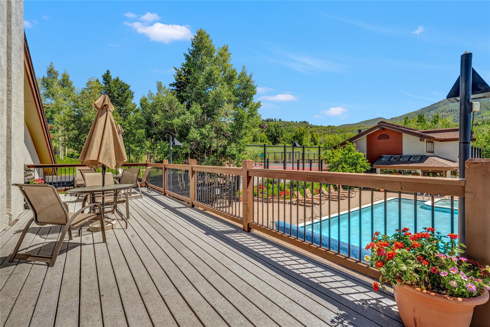 1720 Ranch Road, Unit 309 Steamboat Springs, CO 80487 - Photo 39 of 43 a view of a balcony with wooden floor and outdoor seating