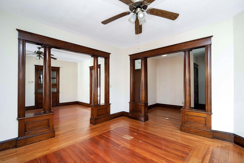 84 Orange Street Springfield, MA 01108 - Photo 22 of 42 a view of an empty room with window and wooden floor