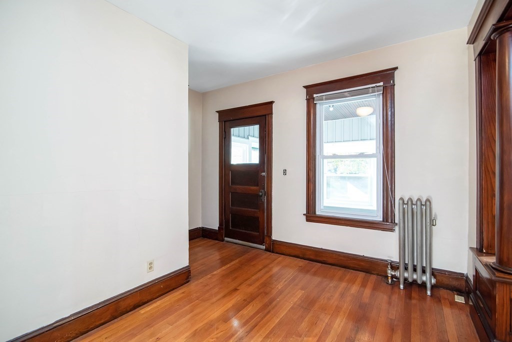 84 Orange Street Springfield, MA 01108 - Photo 25 of 42 an empty room with wooden floor and windows