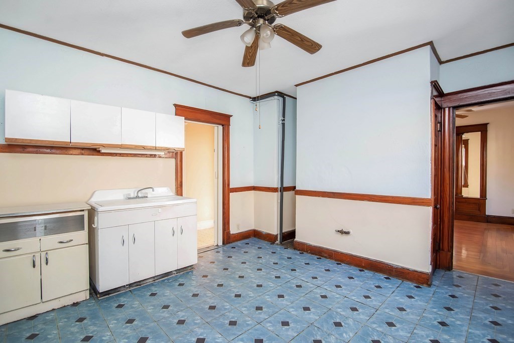 84 Orange Street Springfield, MA 01108 - Photo 29 of 42 a hallway with a white cabinets and wooden floor