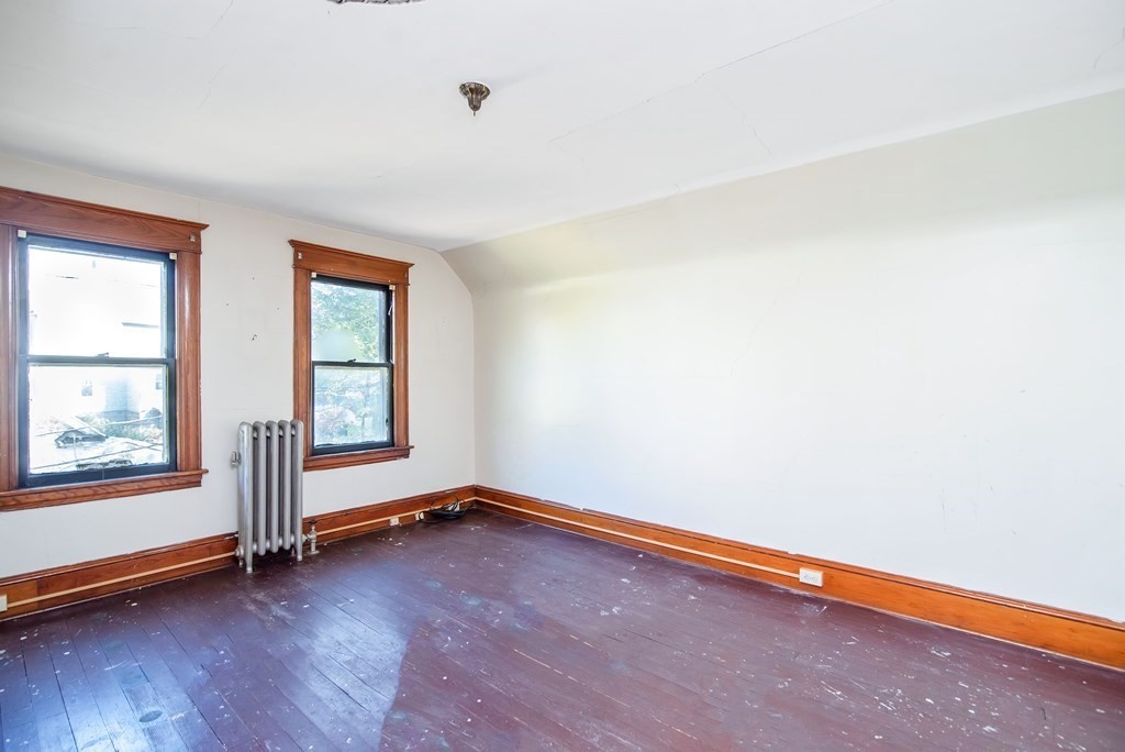 84 Orange Street Springfield, MA 01108 - Photo 31 of 42 an empty room with wooden floor and windows