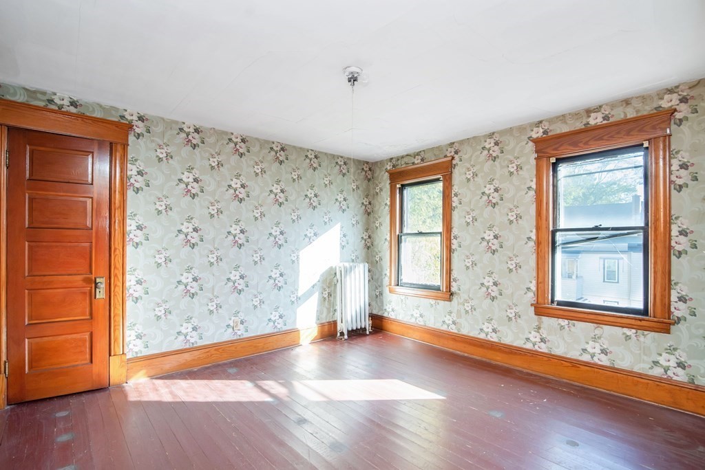 84 Orange Street Springfield, MA 01108 - Photo 32 of 42 wooden floor in an empty room with a window