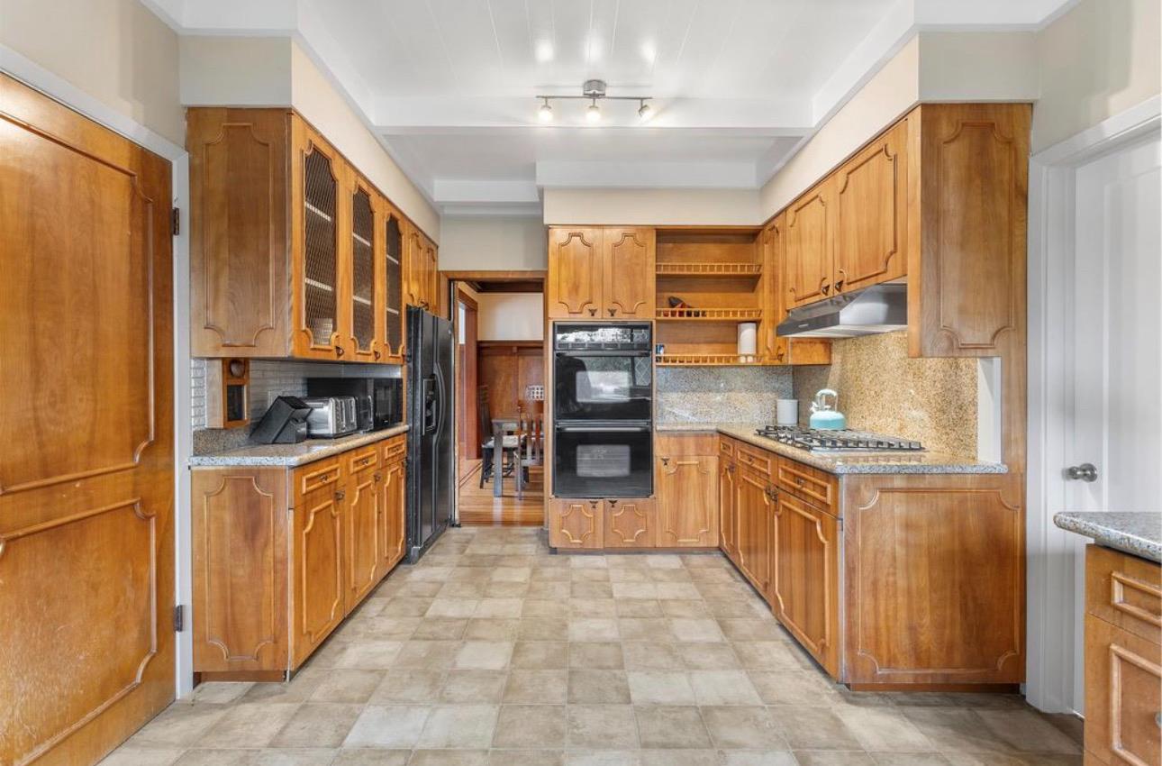 1556 E Street Hayward, CA 94541 - Photo 11 of 65 a large kitchen with stainless steel appliances granite countertop a stove top oven a sink dishwasher and a refrigerator