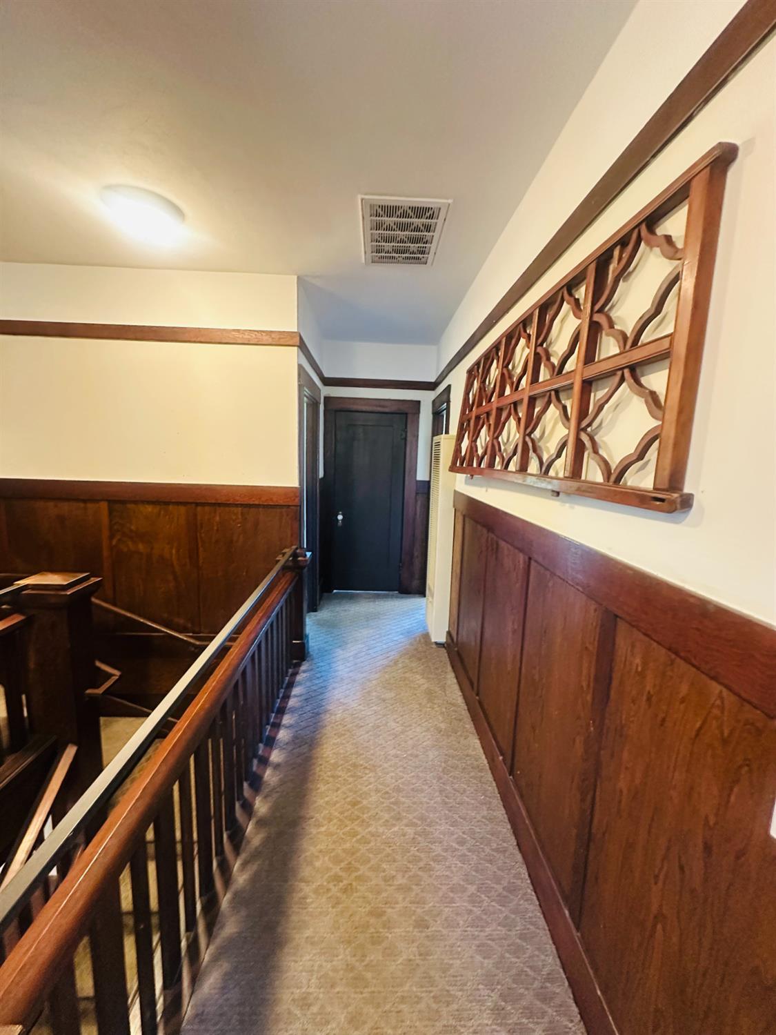 1556 E Street Hayward, CA 94541 - Photo 19 of 65 a view of a hallway with wooden floor and staircase