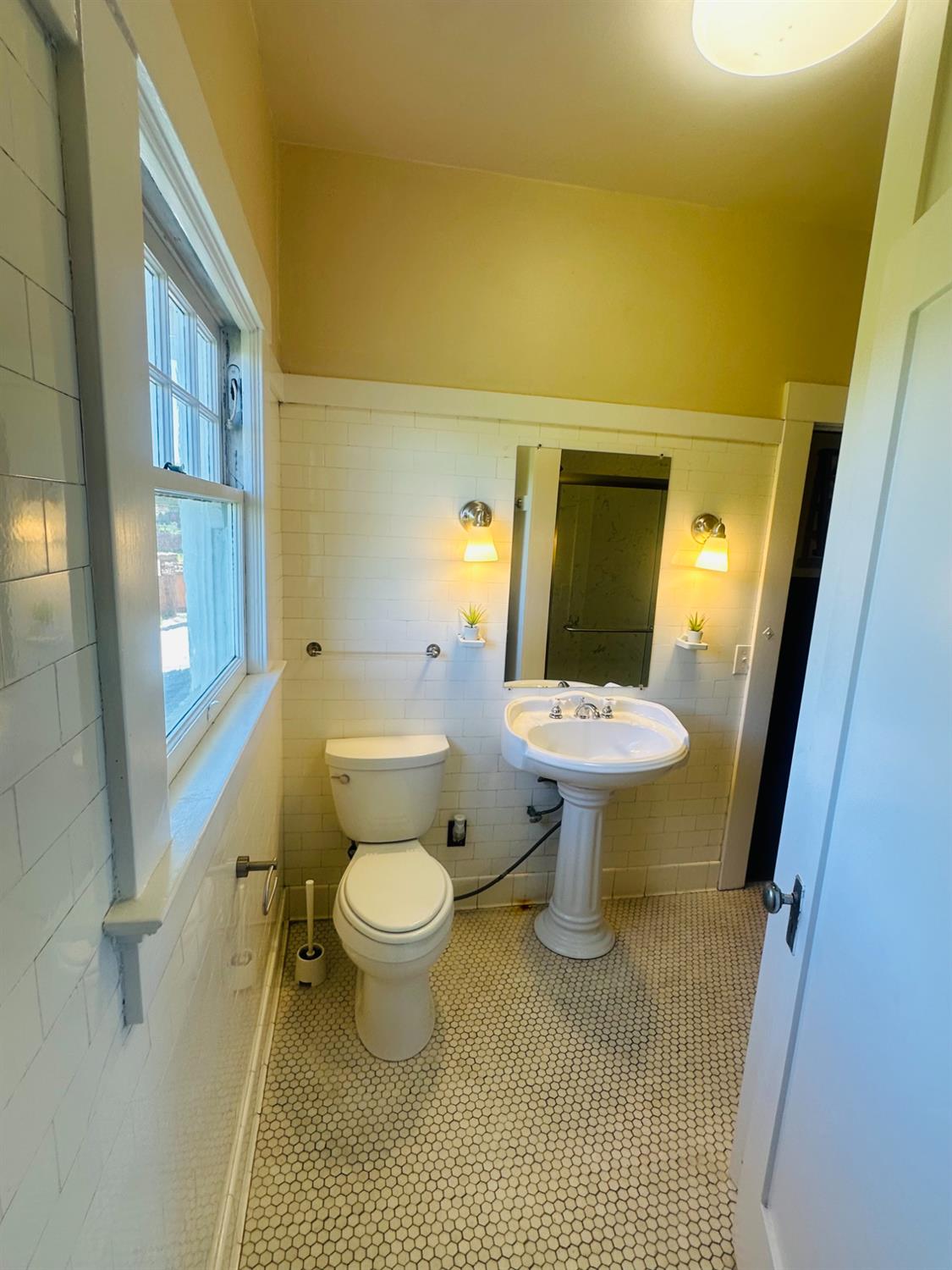 1556 E Street Hayward, CA 94541 - Photo 21 of 65 a bathroom with a sink toilet and a shower
