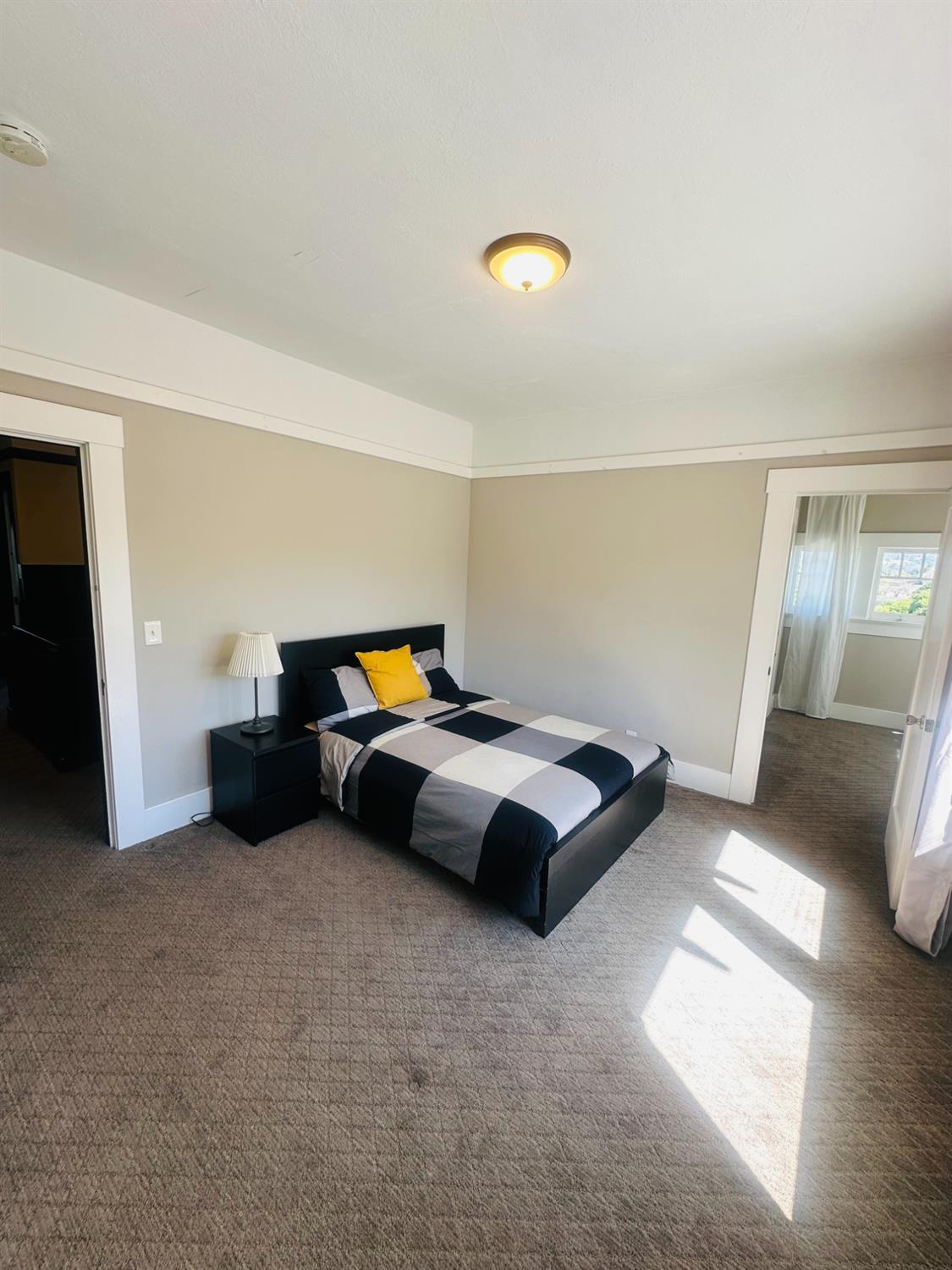 1556 E Street Hayward, CA 94541 - Photo 25 of 65 a bedroom with a bed and a lamp