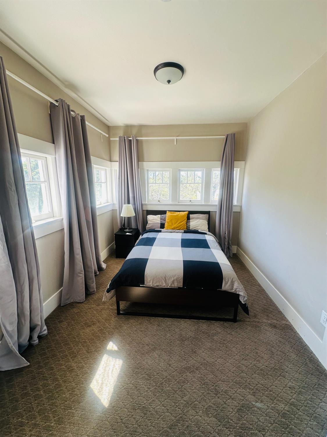 1556 E Street Hayward, CA 94541 - Photo 26 of 65 a bedroom with a bed and window