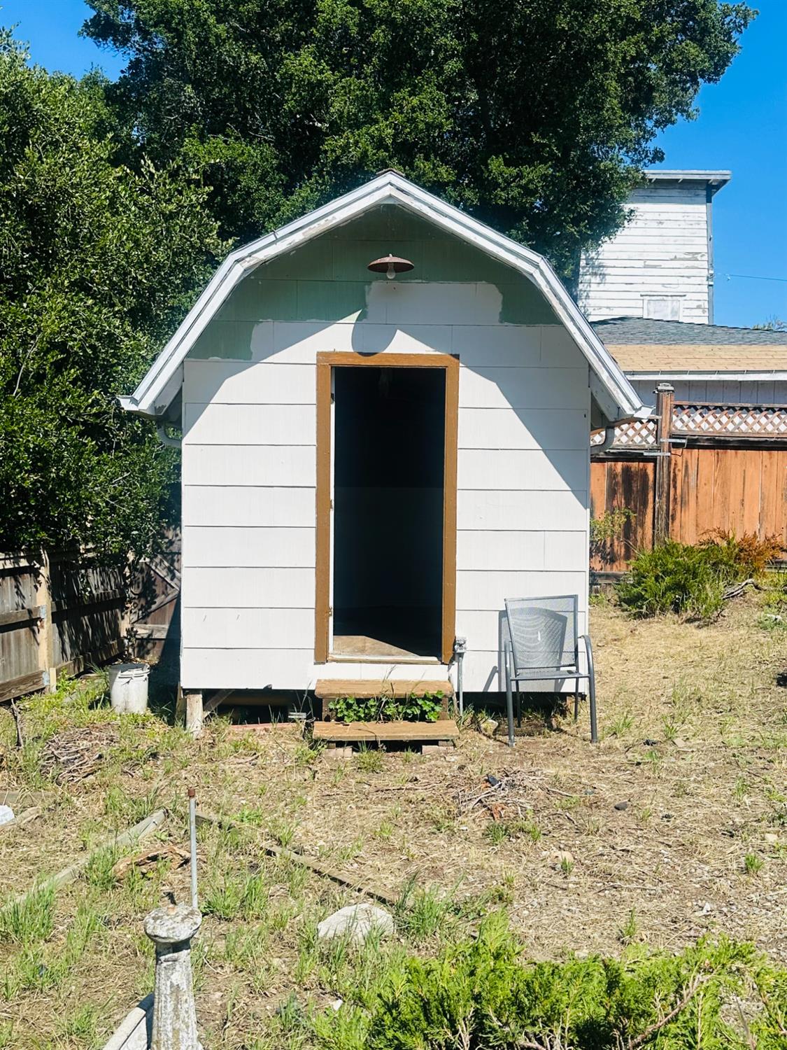 1556 E Street Hayward, CA 94541 - Photo 38 of 65 a small white house with a small yard and large trees