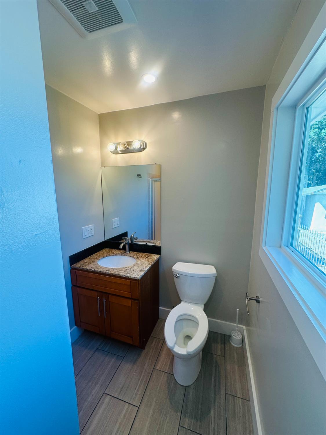 1556 E Street Hayward, CA 94541 - Photo 44 of 65 a bathroom with a toilet a sink and mirror