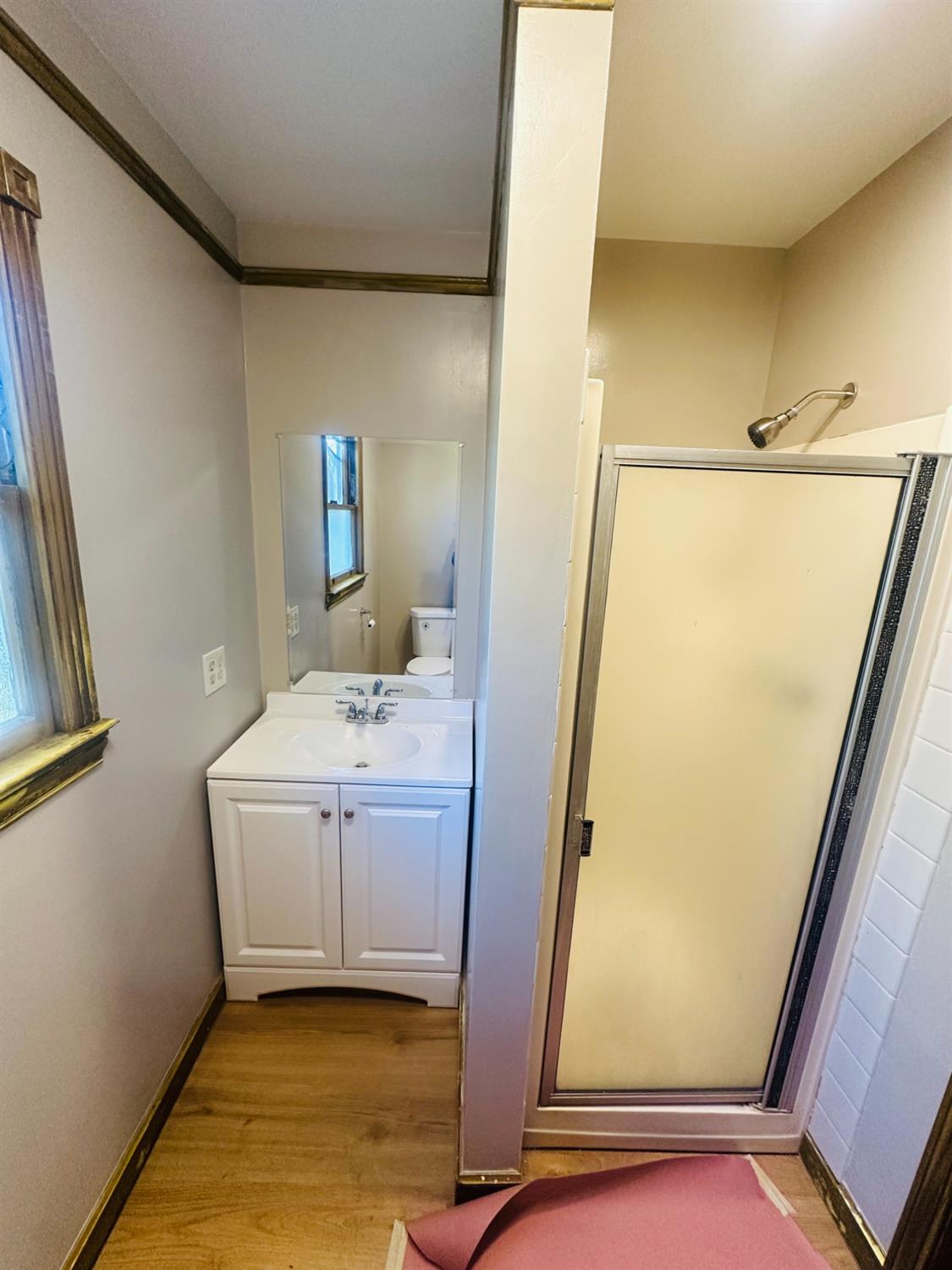 1556 E Street Hayward, CA 94541 - Photo 53 of 65 a bathroom with a sink a mirror and a bath tub