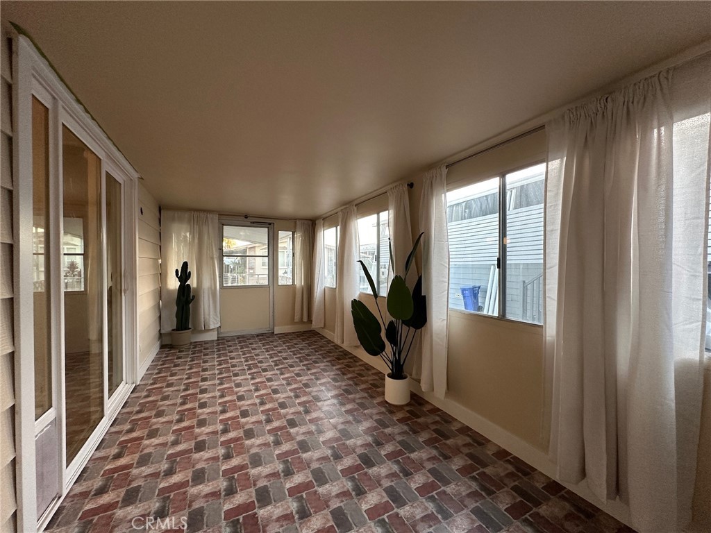 650-291 South Rancho Santa Fe Road San Marcos, CA 92078 - Photo 11 of 40 a view of a hallway with wooden floor and windows