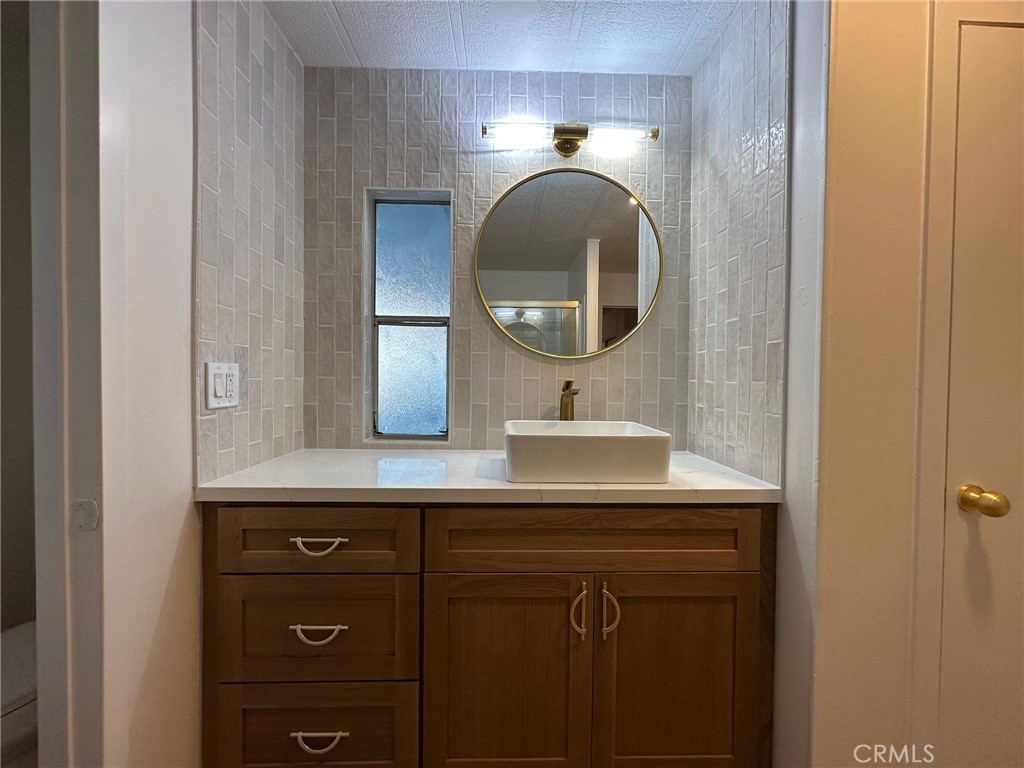 650-291 South Rancho Santa Fe Road San Marcos, CA 92078 - Photo 16 of 40 a bathroom with a double vanity sink and a mirror
