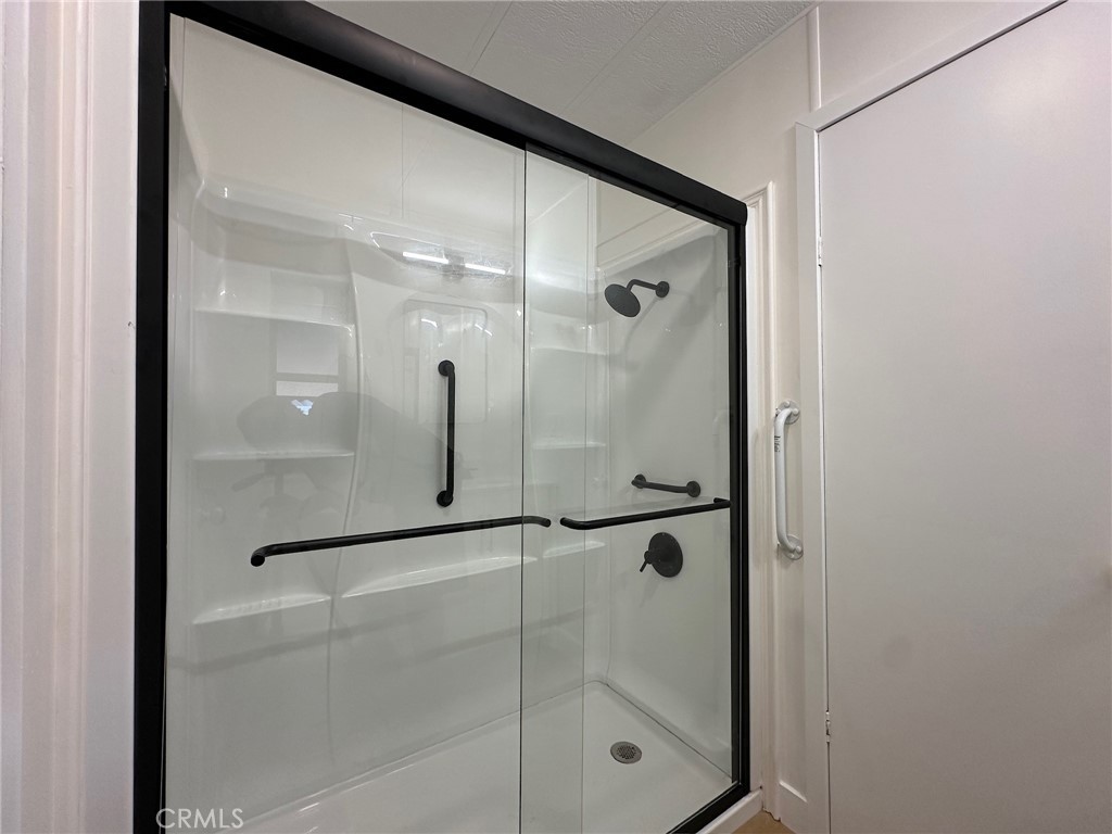 650-291 South Rancho Santa Fe Road San Marcos, CA 92078 - Photo 23 of 40 a bathroom with a glass shower door