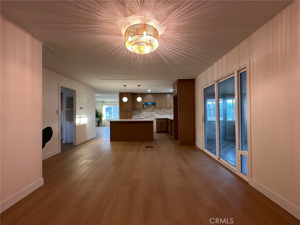 650-291 South Rancho Santa Fe Road San Marcos, CA 92078 - Photo 27 of 40 a view of a kitchen with kitchen island wooden floors stainless steel appliances