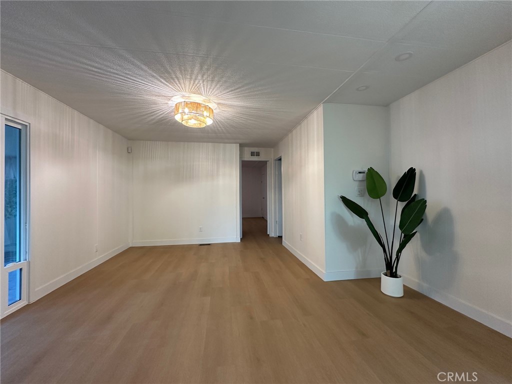 650-291 South Rancho Santa Fe Road San Marcos, CA 92078 - Photo 30 of 40 a view of empty room with wooden floor and window
