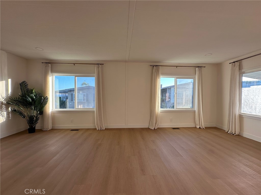 650-291 South Rancho Santa Fe Road San Marcos, CA 92078 - Photo 4 of 40 an empty room with wooden floor and windows