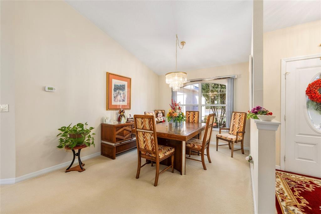 4670 Southwest 158th St Road Ocala, FL 34473 - Photo 14 of 42 a view of a dining room with furniture and a chandelier
