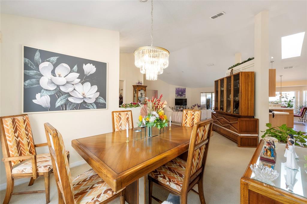 4670 Southwest 158th St Road Ocala, FL 34473 - Photo 16 of 42 a dining room with furniture and chandelier