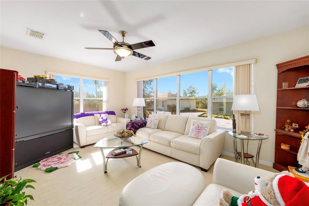 4670 Southwest 158th St Road Ocala, FL 34473 - Photo 22 of 42 a living room with furniture and a flat screen tv