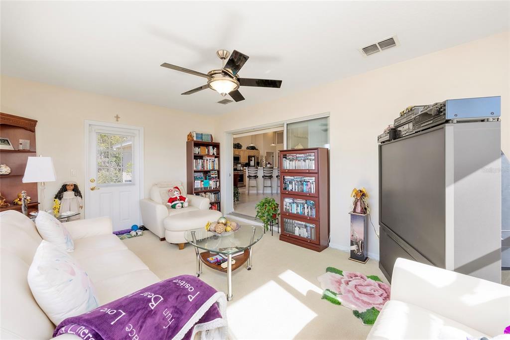 4670 Southwest 158th St Road Ocala, FL 34473 - Photo 23 of 42 a living room with furniture and a book shelf